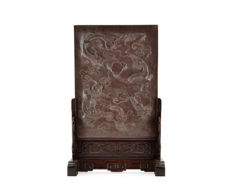 A CHINESE DUAN STONE TABLE SCREEN, QING DYNASTY Carved to one side in relief with three writhing scaly dragons chasing a flam