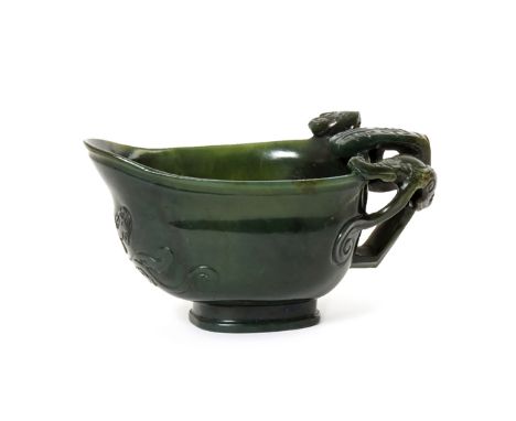 A CHINESE SPINACH-GREEN JADE LIBATION CUP 19TH CENTURY The rounded body with a flaring lip, carved to one end with a bevelled