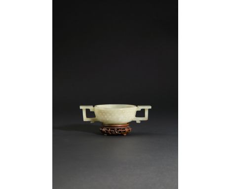 A CHINESE CELADON JADE TWO-HANDLED CUP, 18TH CENTURY The shallow U-shaped body carved with four rows of studs, the handles wi