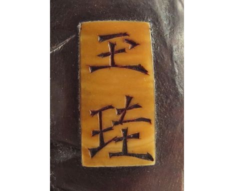 TWO JAPANESE WOOD NETSUKE MEIJI 1868-1912 The first carved as Saigyo Hoshi sitting with his hat and staff on the slopes of Mo