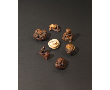 SEVEN JAPANESE NETSUKE 18TH AND 19TH CENTURIES One in stag antler carved as a frog, one a corozo nut carved as an elderly man