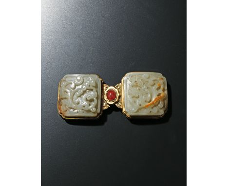 A CHINESE CELADON JADE GILT METAL-MOUNTED BELT BUCKLE, 18TH CENTURY Set with two panels carved with sinuous chilongs and ling