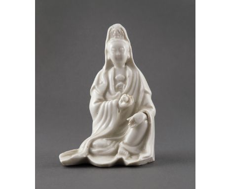 A CHINESE BLANC DE CHINE MODEL OF GUANYIN 18TH CENTURY In a seated position, her left hand resting on her knee with her robes