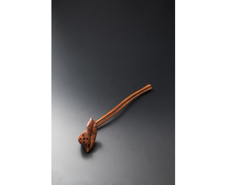 A JAPANESE BOX WOOD SASHI NETSUKE 19TH CENTURY With two long lotus stems forming the shaft, one issuing a curled leaf, the ot
