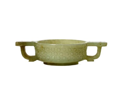 A SMALL CHINESE CELADON JADE TWO-HANDLED CUP QING DYNASTY The compressed circular body with a ring foot and carved in relief 