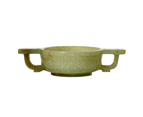 A SMALL CHINESE CELADON JADE TWO-HANDLED CUP QING DYNASTY The compressed circular body with a ring foot and carved in relief 