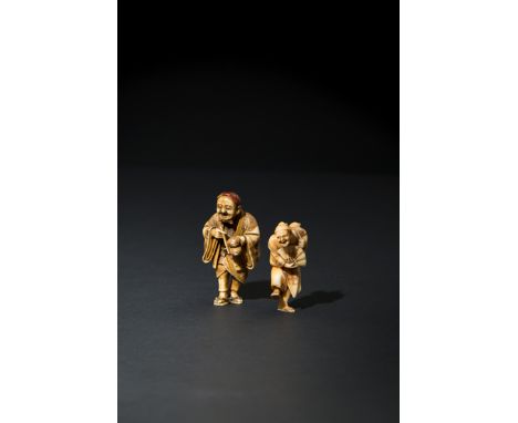 TWO JAPANESE IVORY NETSUKE MEIJI 1868-1912 The first carved as a man holding bells, the details picked out in coloured lacque