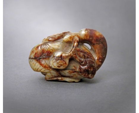 A CHINESE BROWN JADE CARVING OF A GOOSE MING/QING DYNASTY Seated with its head turned over its back, its feet tucked beneath 