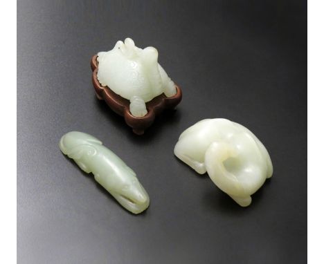 THREE CHINESE PALE CELADON JADE CARVINGS, 18TH/19TH CENTURY One formed as a recumbent camel, another a reclining hound, the t