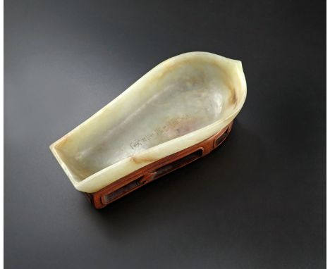 A CHINESE PALE CELADON JADE SPOON MODELLED AS A BOAT, MING DYNASTY The exterior carved with swirling and crashing waves, the 