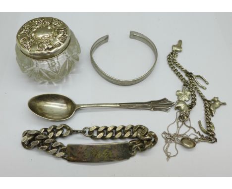 A collection of silver and white metal items including a silver topped pot, spoon and bangle and two bracelets, ID bracelet m