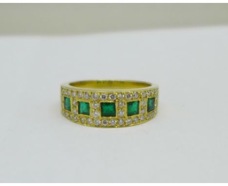 A yellow metal, emerald and diamond ring, marked 750 in the shank, 6.1g, O 