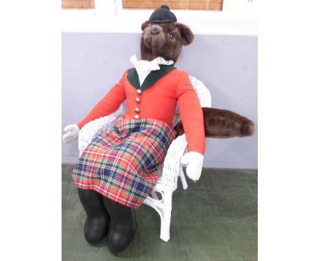 A hunting fox soft toy doll on a painted wicker chair 