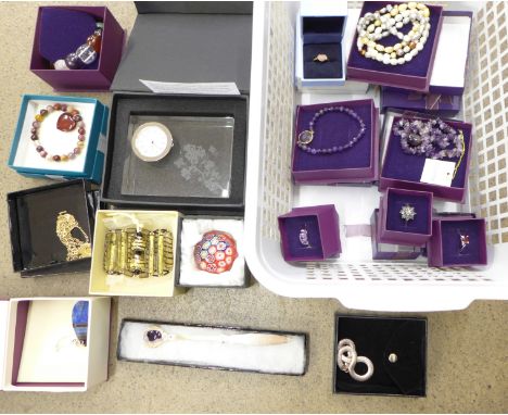 A collection of costume jewellery including a silver ring and bracelet, a clock and a paperweight 