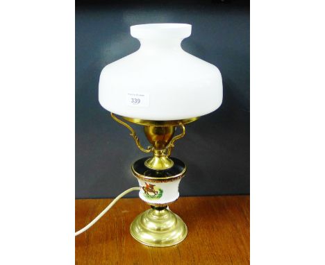 A table lamp with opaque glass shade and brass foot rim