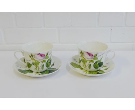 Two Roy Kirkham 'Redoute Roses' cup and saucers, (2) 