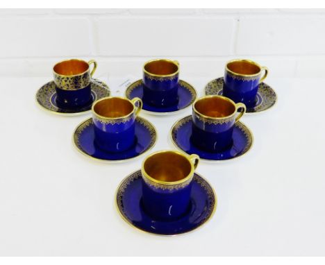 Crown Devon 'Fieldings' coffee cans and saucers with cobalt blue ground and gilt interiors, comprising eight coffee cans and 