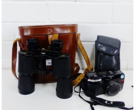 A pair of Elemme Kassel Sonoram 10 x 45 binoculars contained within a brown leather carry case, together with an Olympus came