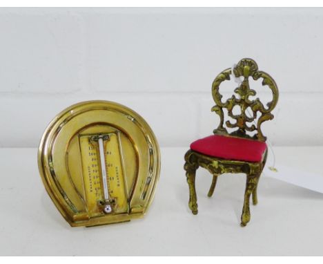 A miniature brass chair, 9.5cm high, together with a brass framed horseshoe thermometer, (2) 
