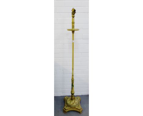 A cream painted wooden standard lamp with green foliate and ribbon swag pattern