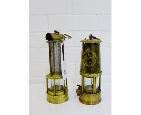 An Eccles brass miners lamp, together with a Stephenson's type brass safety lamp, (2) 
