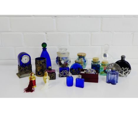A collection of contemporary blue glass and white metal mounted scent bottles, together the a small mantle clock etc., (a lot
