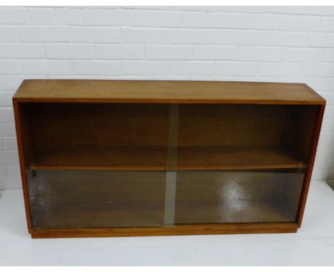 A teak book shelf with glazed doors, 64 x 122cm 