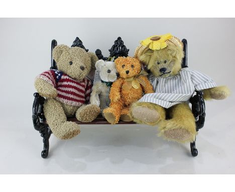 A Russ Bears from the Past wrought iron park bench with maker's tag, 27.5cm by 42cm, together with four plush teddy bears inc