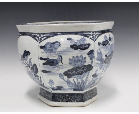 A chinoiserie blue and white pottery planter, hexagonal with fish  and lily pad pattern, 37cm 