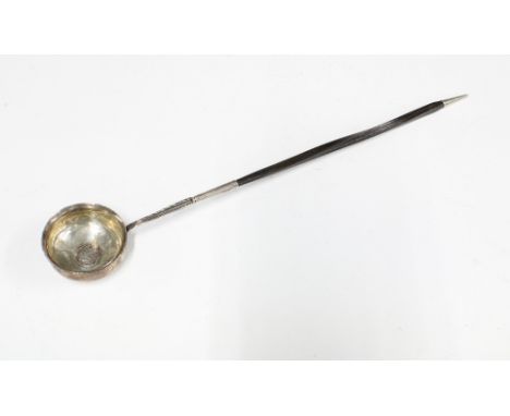 Georgian unmarked white metal toddy ladle, the bowl inset with a coin, baleen handle, 39cm long 