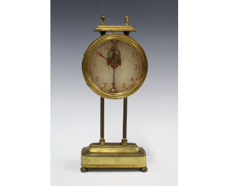 Brass cased Mystery Gravity mantle clock, with red painted arabic numerals, case numbered PAT 15238, 26cm 