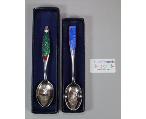 Two silver and enamel Christmas spoons, 'Christmas 1928 the fir tree' and 'Christmas 1976 Angus Dei', original boxes. (2) (B.