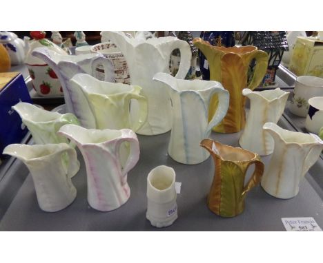 Collection of Royal Worcester leaf jugs, various colours and sizes, two with gilded edging, together with a Royal Worcester t