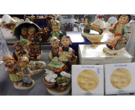 Tray of West German Goebel Hummel figures, two figures with original boxes And two box miniature plates. (10 (B.P. 21% + VAT)