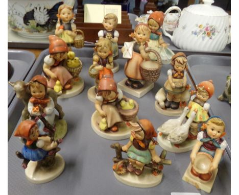 Tray of Goebel Hummel West German figurines of little girls in various poses, some with animals. (B.P. 21% + VAT)Appear to be