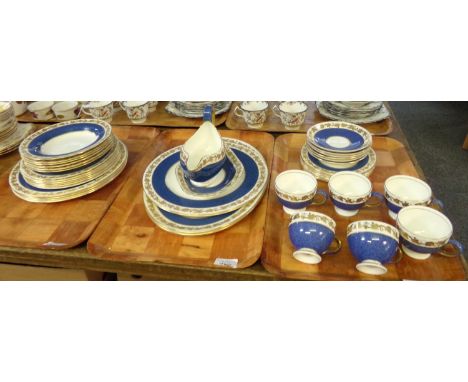 Three trays of Wedgwood English bone china blue and gilt vine pattern items to include: teacups and saucers, various plates, 