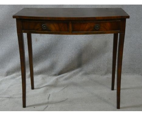 A Regency style flame mahogany console table fitted with frieze drawers on sabre supports. H.77 L.85 W.46cm 