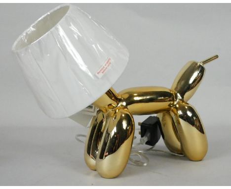 A Jeff Koon inspired table lamp in the form of a gold balloon dog with white shade head. H.30cm 