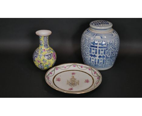 A Chinese Famille Rose armorial plate along with an Imperial yellow hand painted porcelain bottle vase with urn and flower mo