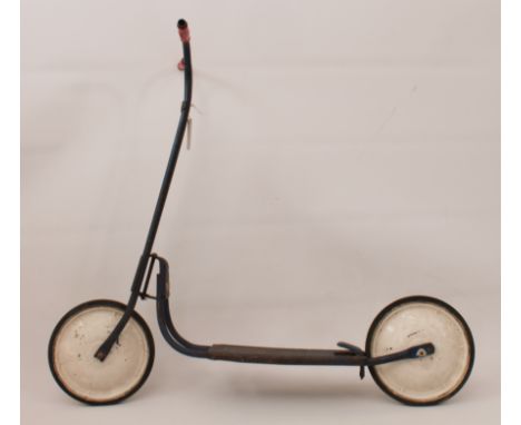 A vintage 1960s child's scooter - the steel frame painted metallic blue, with rear wheel foot operated brake and red plastic 