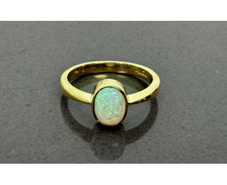 A heavy 9ct gold ring set with an oval-shaped opal - Birmingham hallmarks, size O/P.
