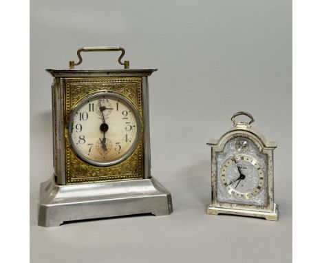 Two clocks, comprising - 1. A 1970s Swiza bedside or desk clock, manual wind with alarm, the arched silvered brass case with 