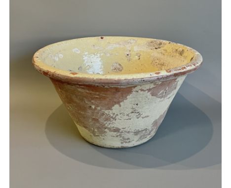 A large vintage cream glazed terracotta dairy bowl - the base drilled for use as a planter, 43.2cm diameter, glaze losses.