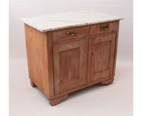 A waxed pine and white marble side cabinet - with two short drawers over two cupboard doors, the interior with removable shel
