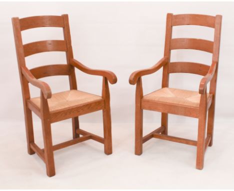 A pair of honey oak kitchen carver chairs - late 20th century, ladder backs and rush seats, square supports united by an H-st