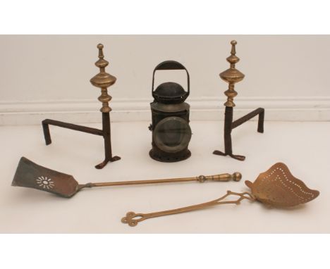 A mixed lot of four: 1. a pair of cast iron and brass fire dogs; 2. a brass skimmer and a fireside coal shove; 3. an oil lant