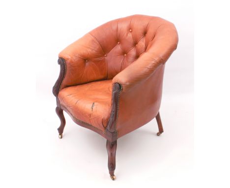 An&nbsp;Edwardian carved mahogany and tan leather tub back chair - with button back, foliate scroll carved arms, serpentine s