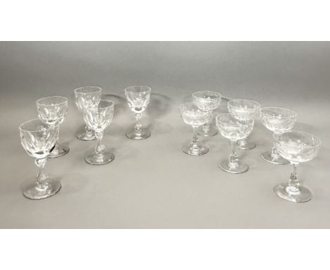 A set of six Edwardian cut glass champagne saucers - the cupped bowls with basal panel cutting, 11.4cm high; together with a 