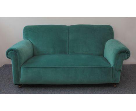 An early 20th century sofa in the Howard style - 1920s-30s, upholstered in teal-blue velour, one end with a drop-arm, on late