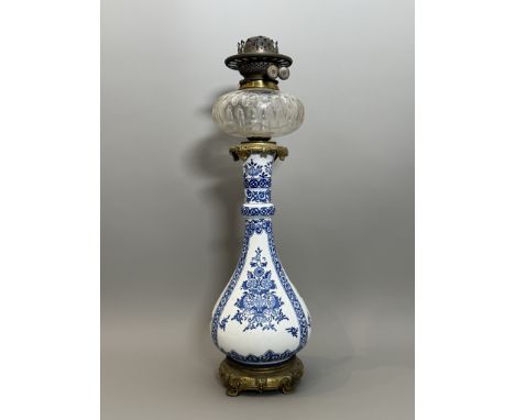 A Delft style earthenware vase oil lamp with gilt bronze mounts - early 20th century, the bottle shaped vase with gilt metal 